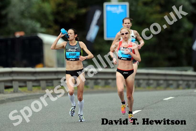 Gemma Steel and Jo Pavey has a drink while taking part in the 2012 BUPA GNR